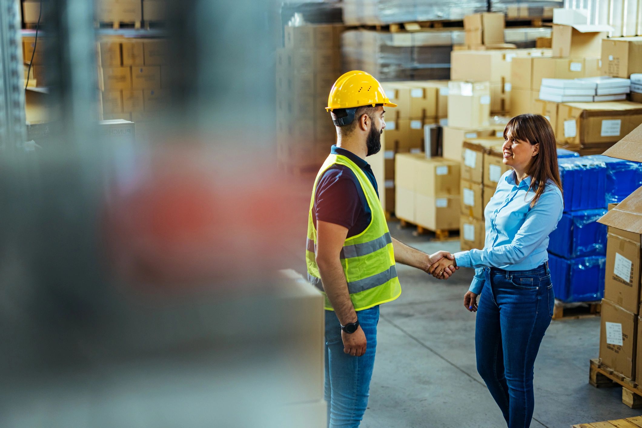 Successful partners handshaking in warehouse of large modern factory