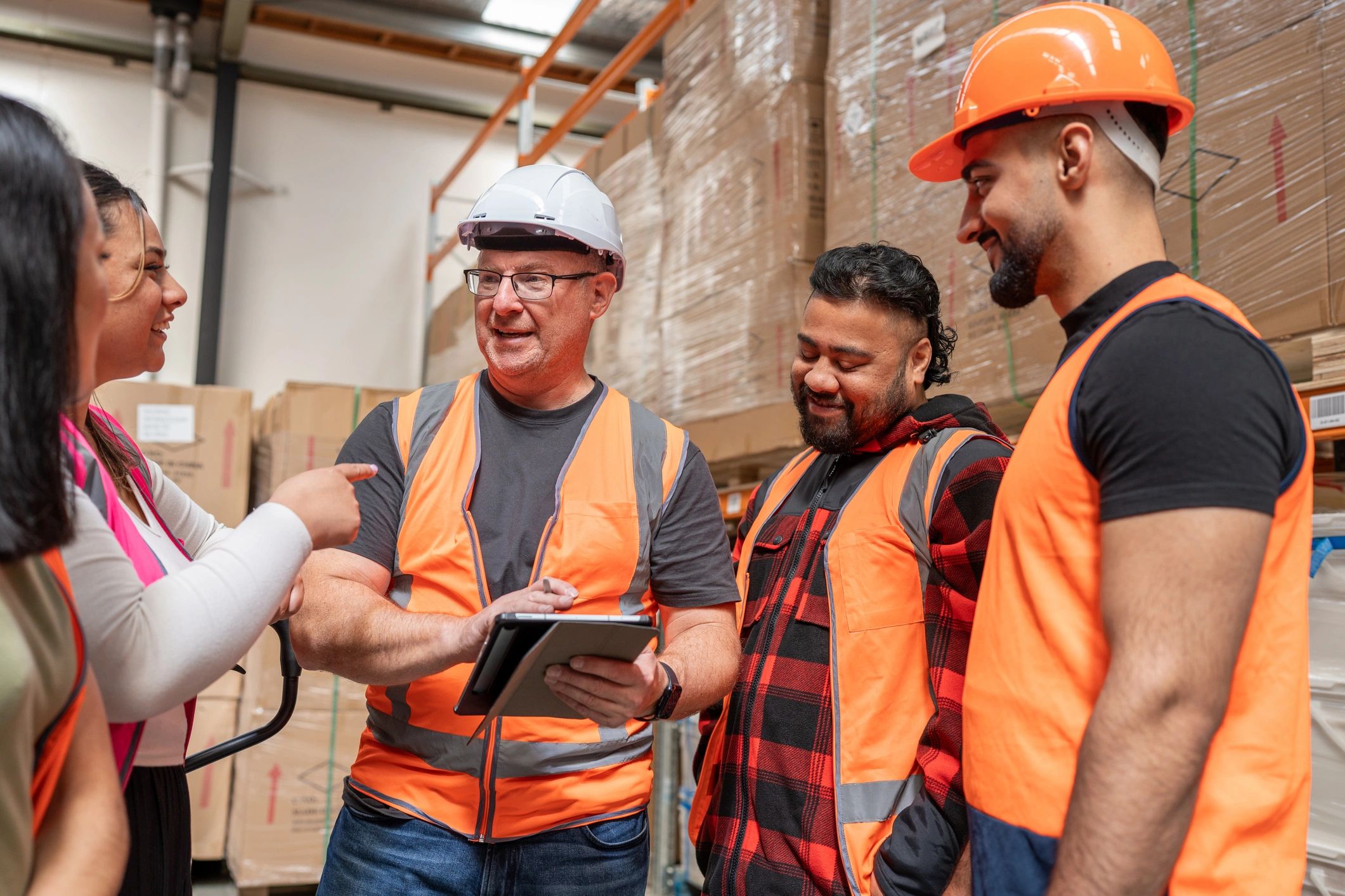 Logistics Colleagues Discussing Work With Tablet
