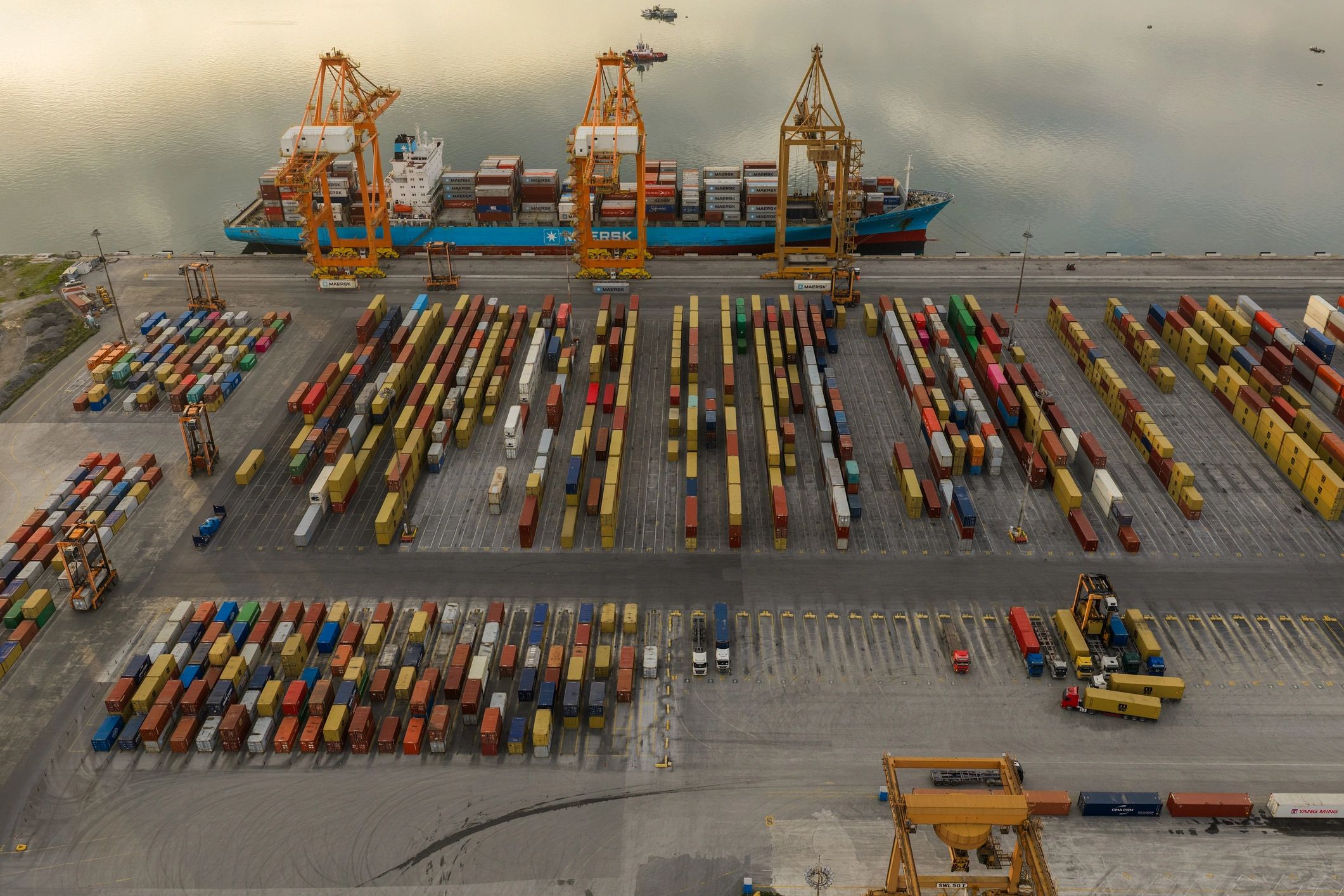 Aerial view of a busy container port with cranes and cargo containers