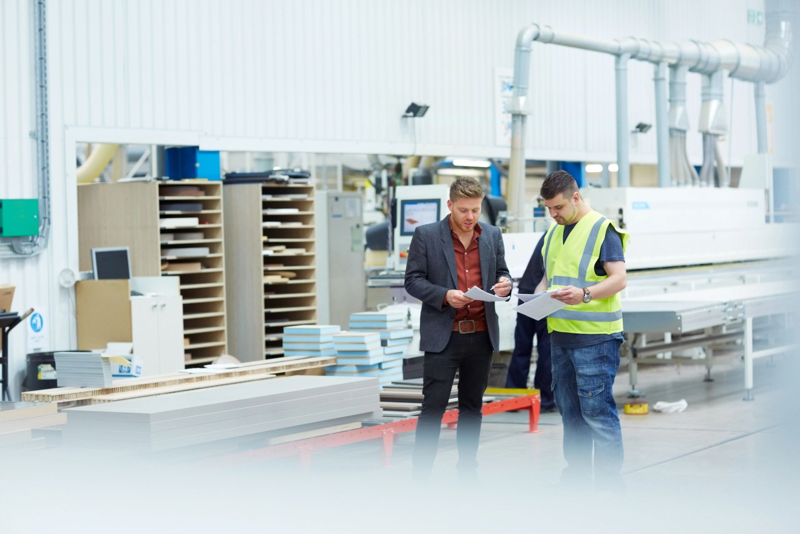 Manager discussing production plan with foreman on a factory floor