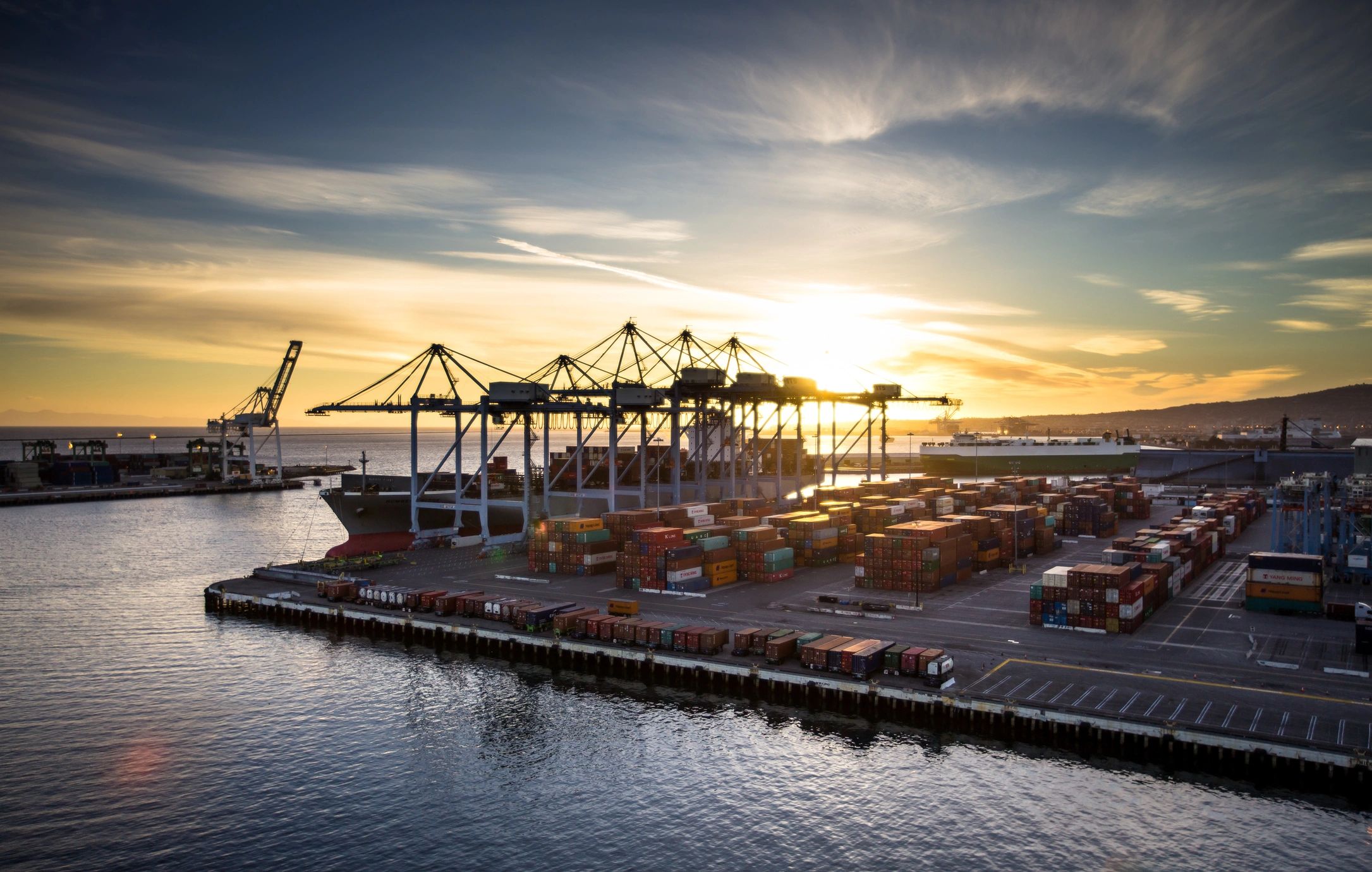 Shipping containers at a major port at sunset